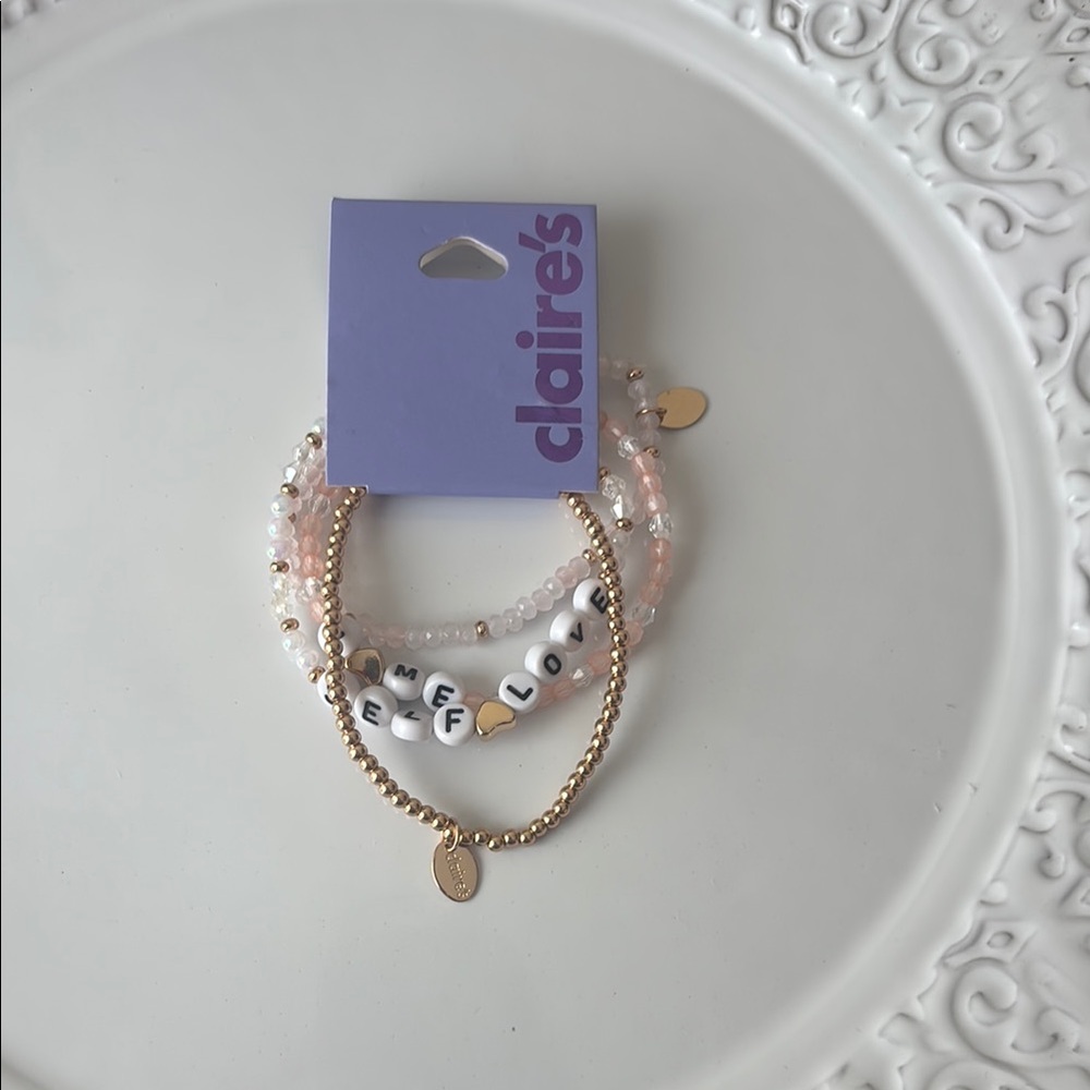 NWOT Claire’s Gold and Pink Set Of 4 Bracelets.